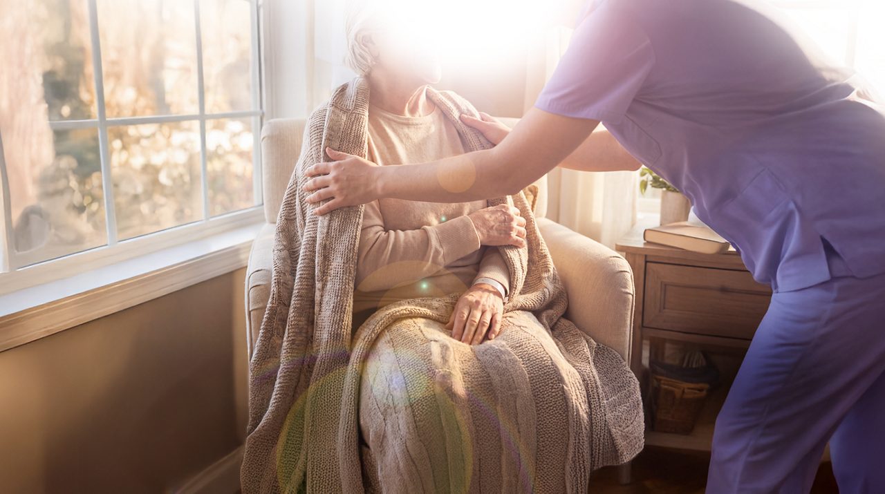 AI generated image of nurse putting blanket on female cancer patient.