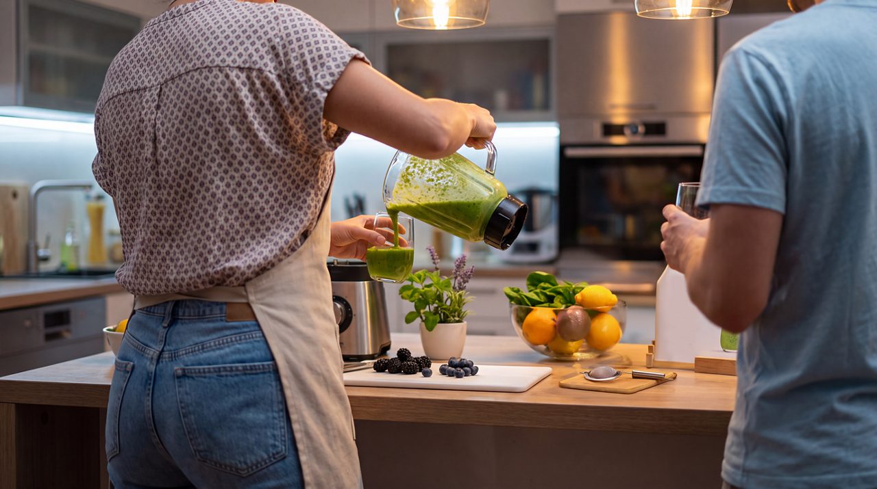 AI generated image of male and female making a smoothie drink.