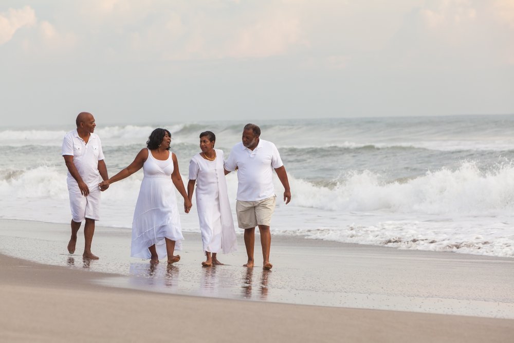 Happy romantic senior African American men and women couples walking holding hands on a deserted tropical beach ; Shutterstock ID 786940225; Business Division: Advanced Medical Nutrition; Business Unit: Benelux; Name: Danique van der Tas