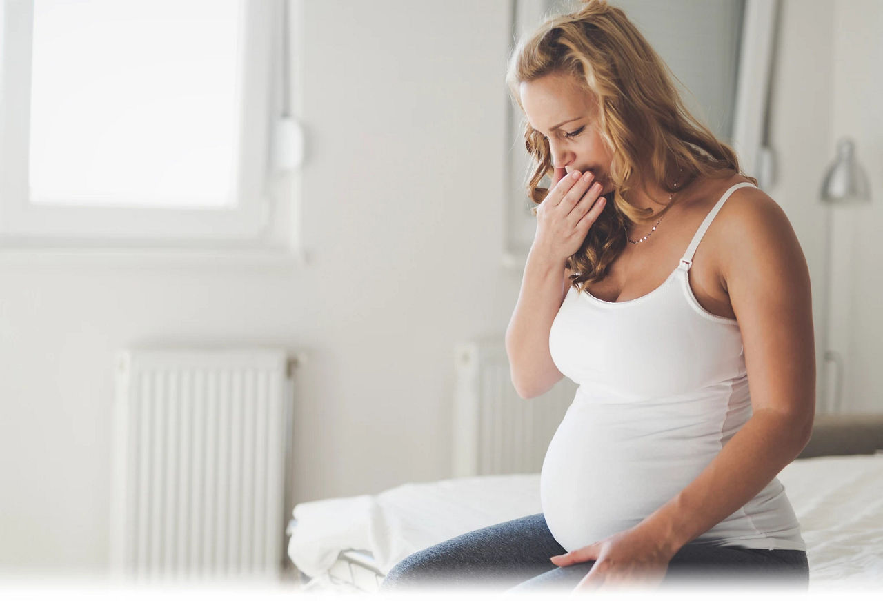 Pregnant woman sitting in bed