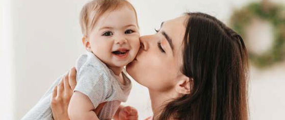 Baby peeking from mother arms