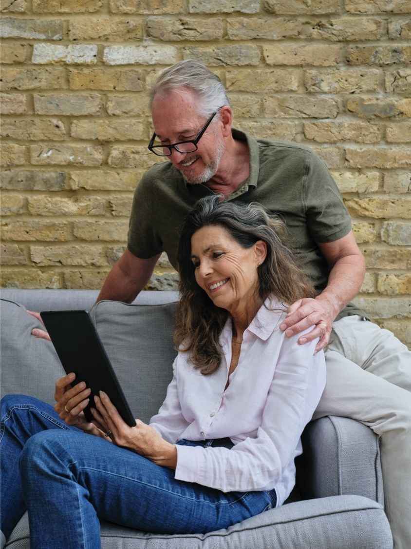 man and woman looking at ipad