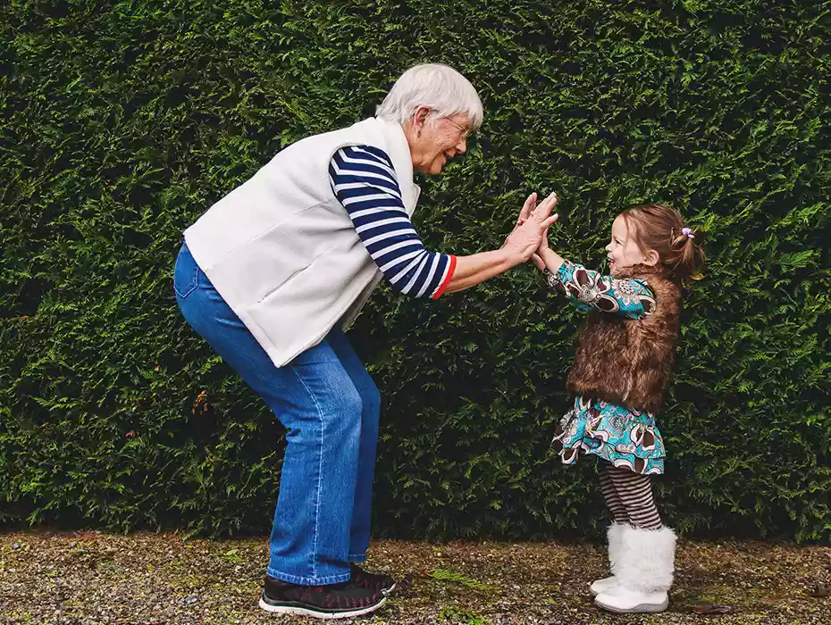 grandma clapping hands with grandaugher 