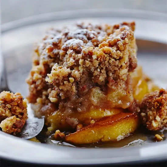 Close up of warm apple crumble dessert