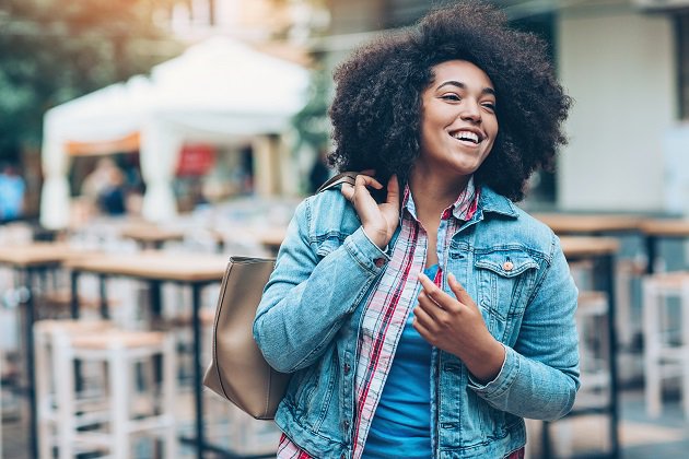 Young African ethnicity woman walking outdoors in the city