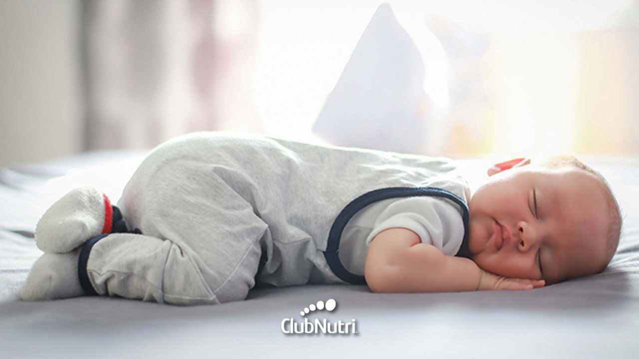 Breastfeeding baby on bed