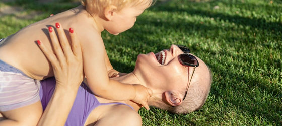 Female cancer patient holding toddler
