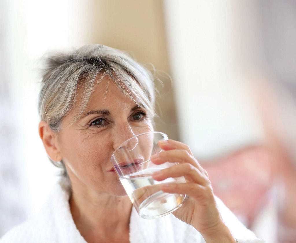 Elderly woman drinking water