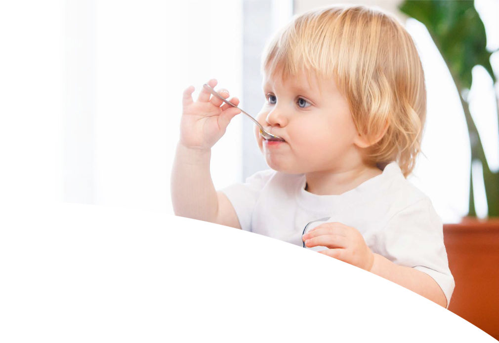 Toddler with a spoon in the mouth