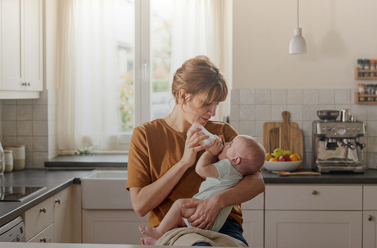 mum feeding baby aptamil