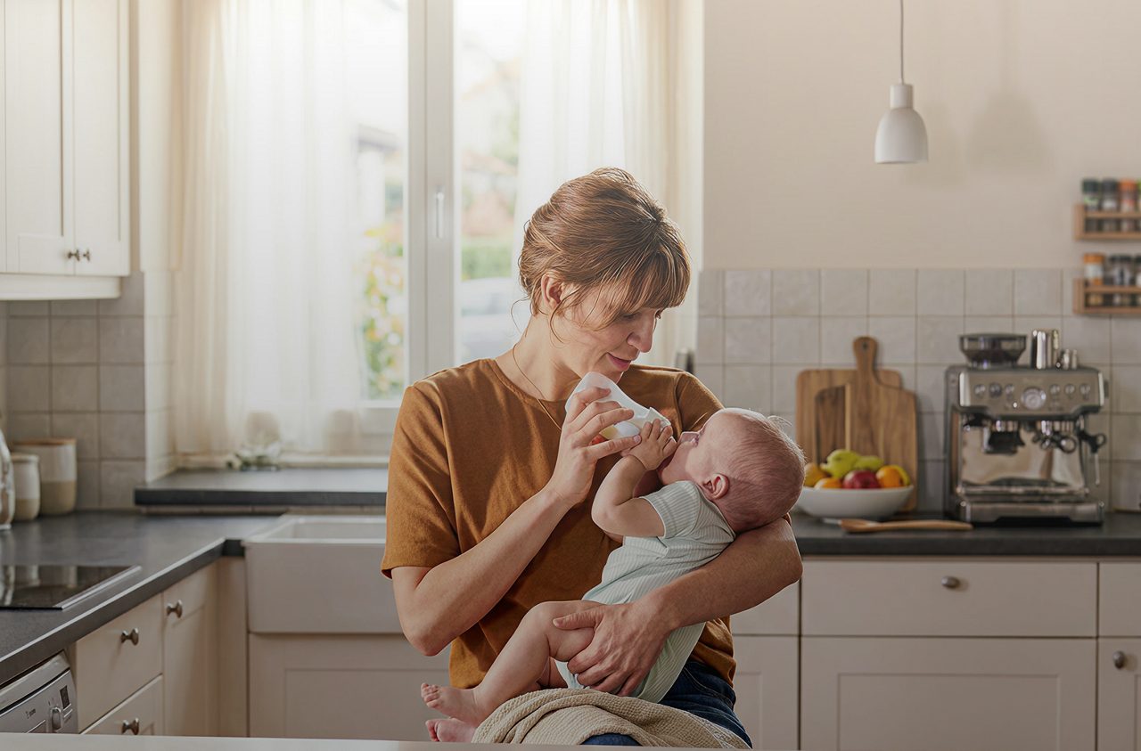 mom feeding baby in the kitchen