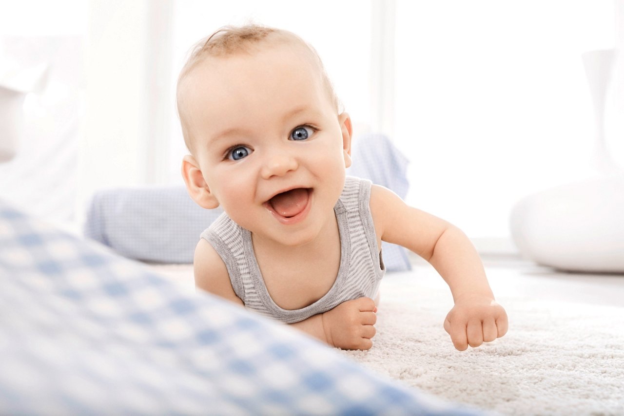 Baby lying on front smiling