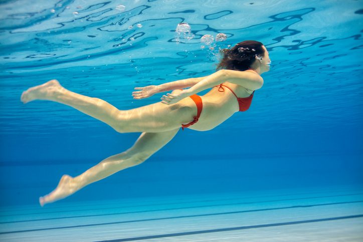 Frau mit Baby schwimmt