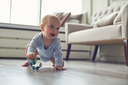 Laughing baby crawling on the floor