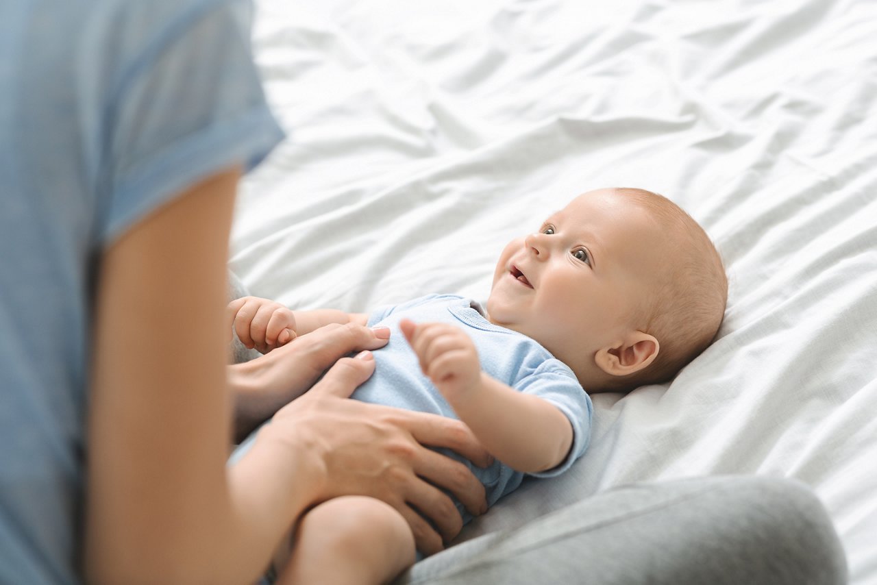 Mother breastfeeding baby on the couch