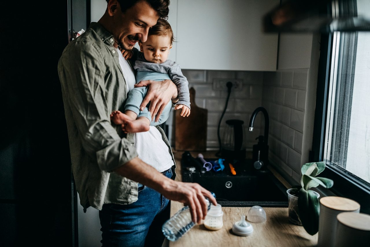 Father feeding his son in kitchen