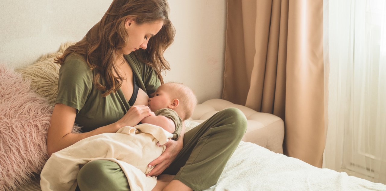 The concept of breastfeeding. Portrait of mom and breastfeeding baby.