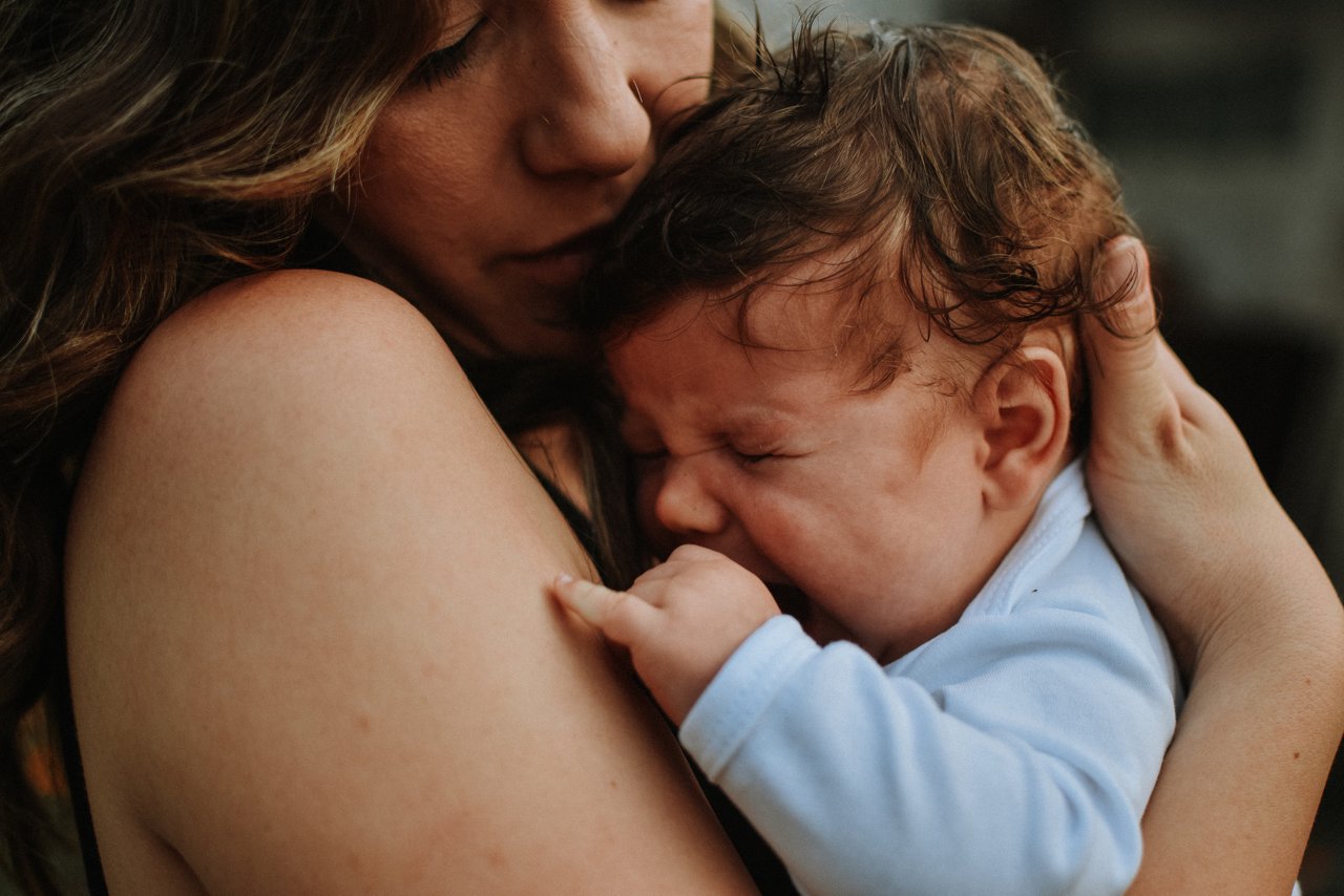 Mother holding crying baby