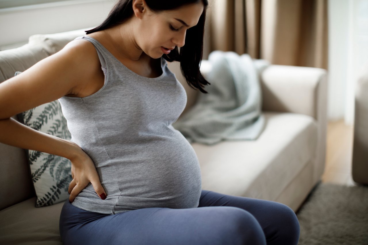 Pregnant woman sitting on couch