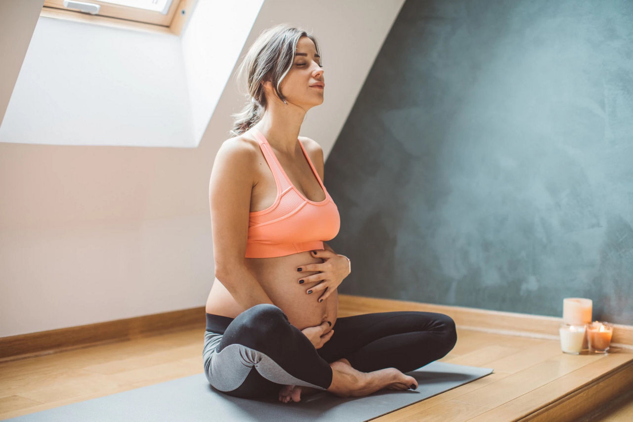 Pregnant woman doing meditation yoga