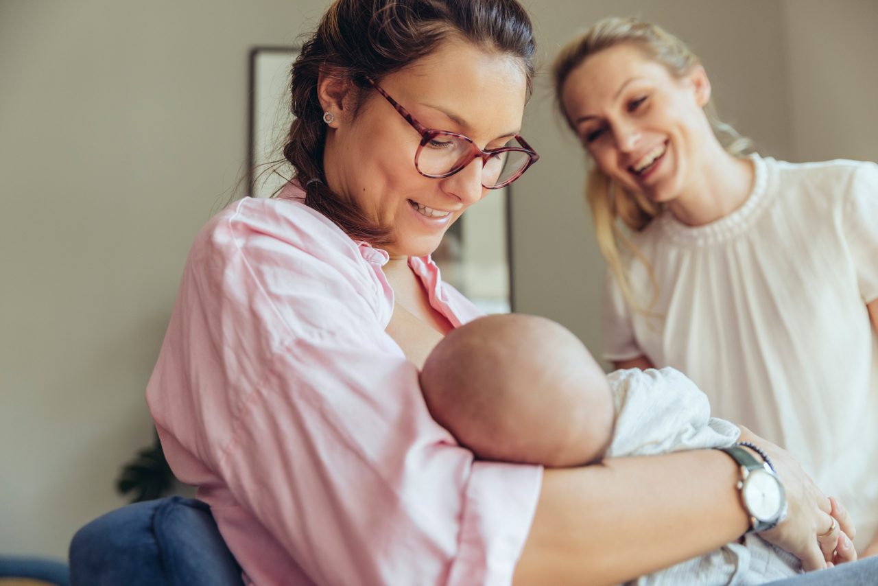 Midwife supporting a breast-feeding mother, Cologne, NRW, Germany