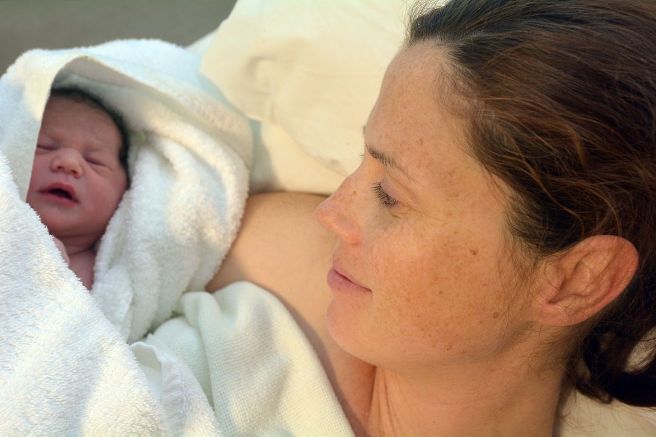Frau mit Baby nach der Entbindung