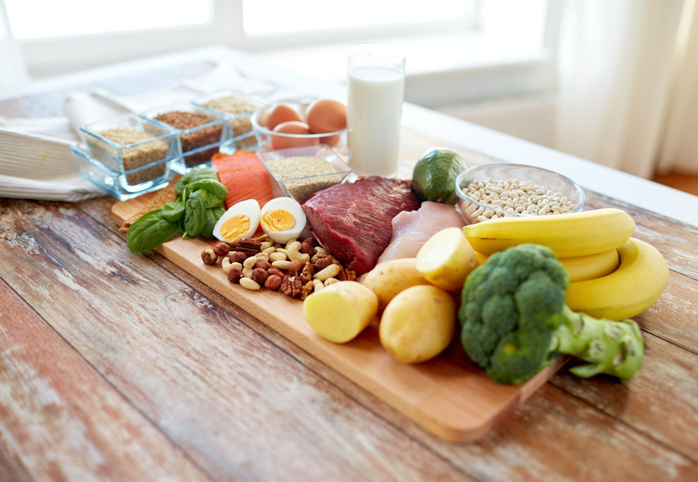 Close up of vegetables, fruit and meat on wooden table