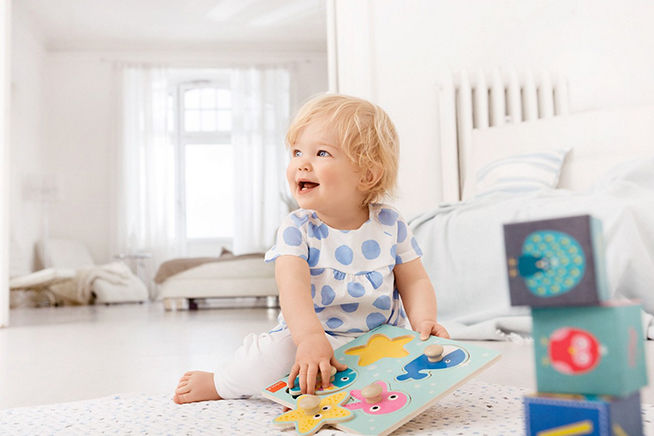 aptaclub toddler playing on the floor