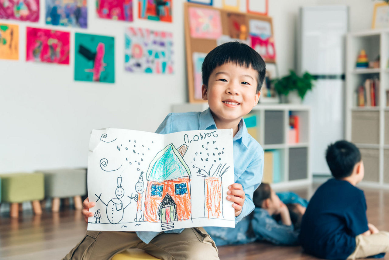 boy smiling with artwork