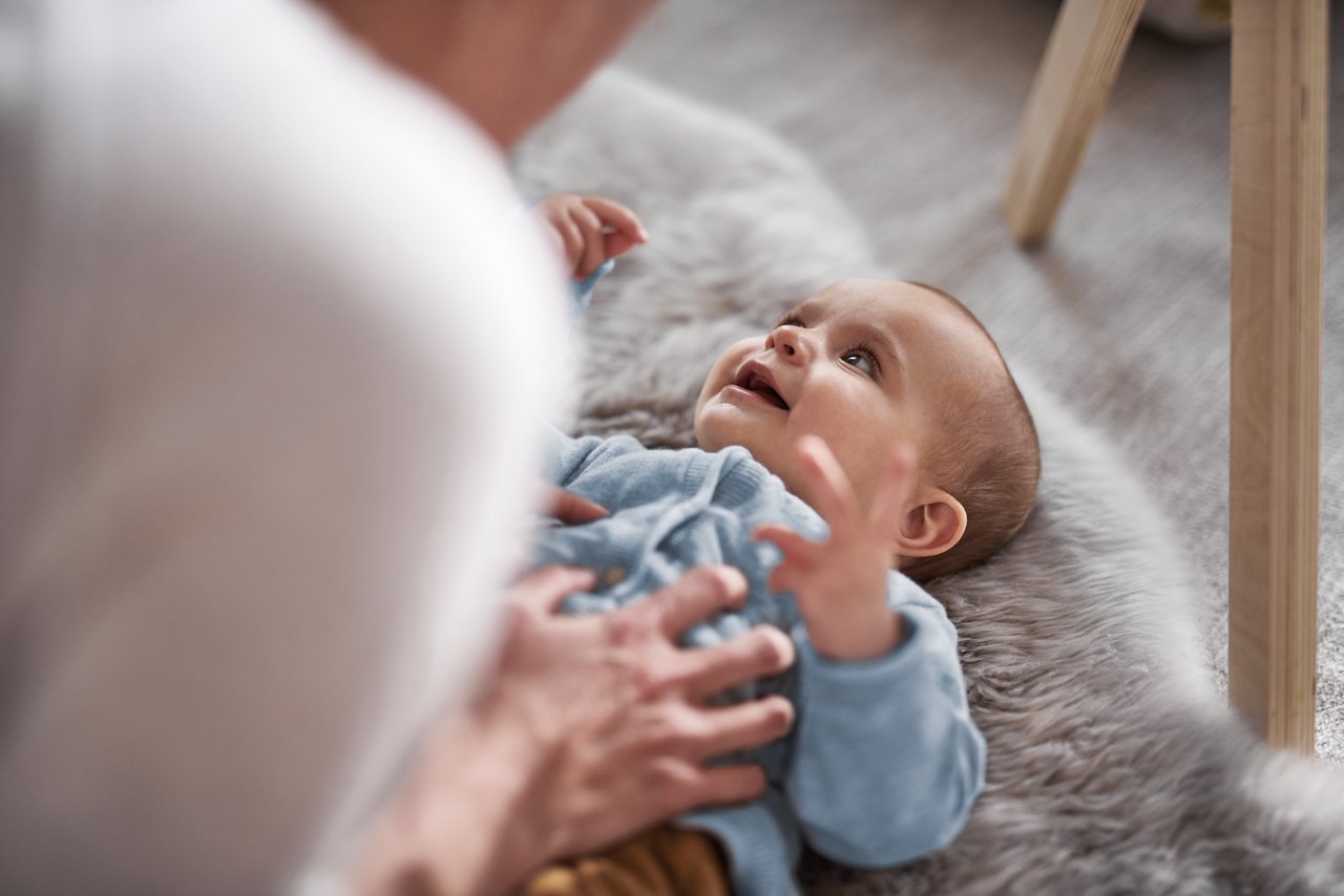 Web only - baby on back bonding with mum indoors