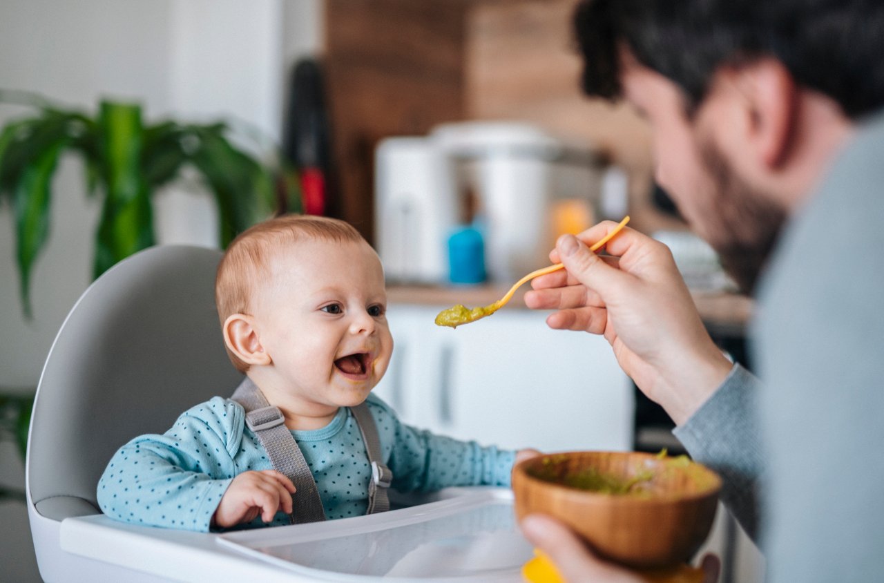 Father feeding baby