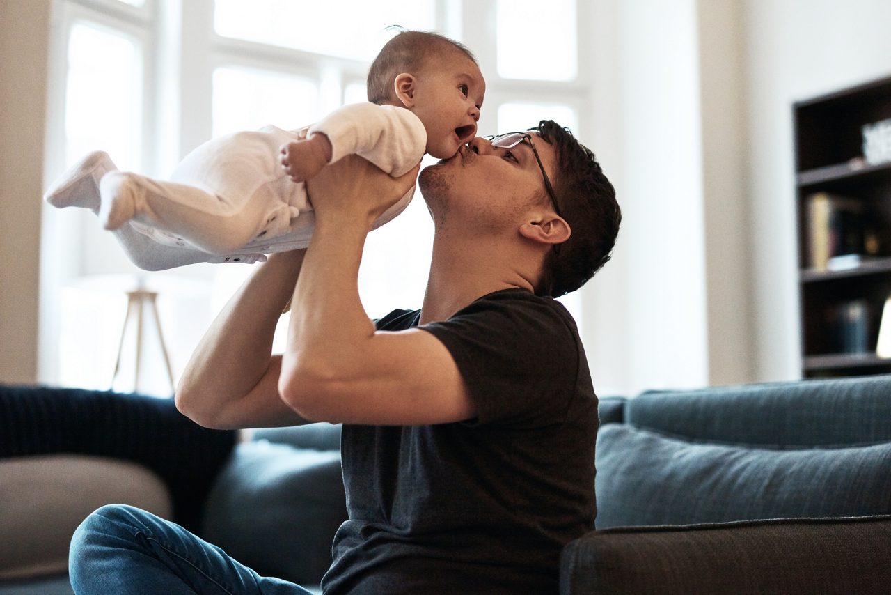 Shot of a happy young father bonding and spending time with his infant daughter at home