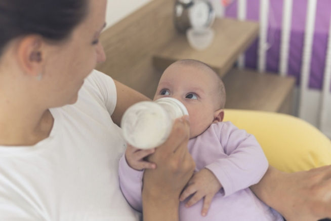 baby bottlefeeding purple