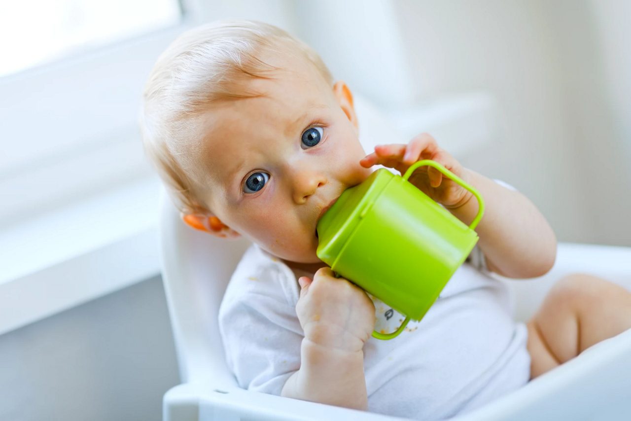 girl-drinking-from-feeding-beaker