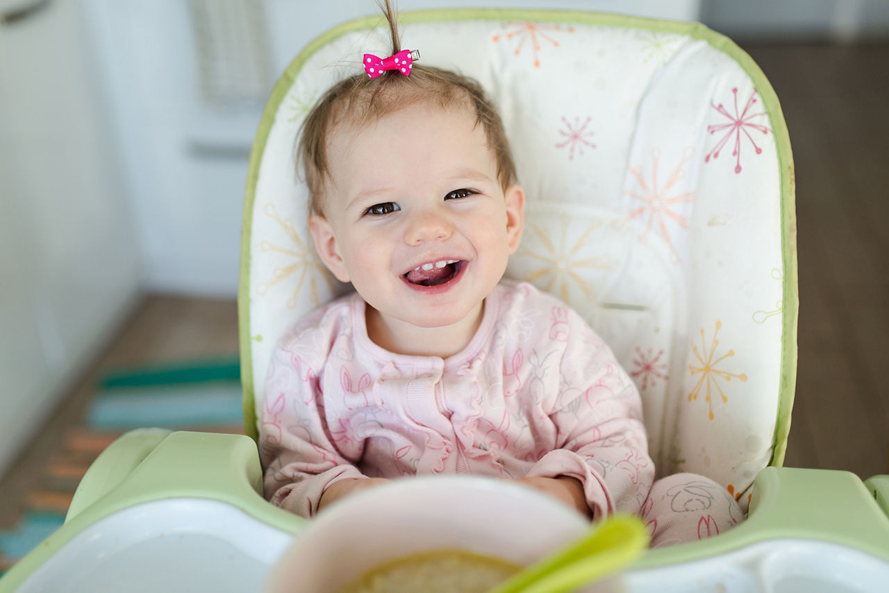 Baby eating porridge breakfast