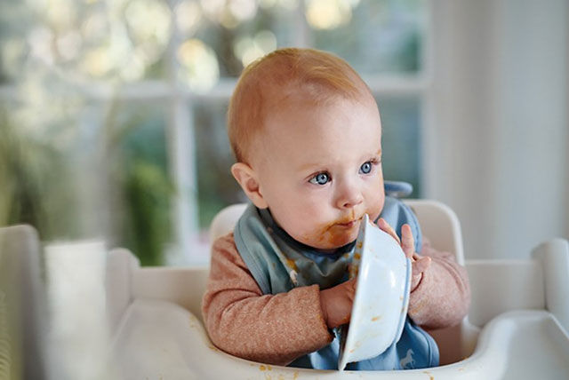 baby eating with hands