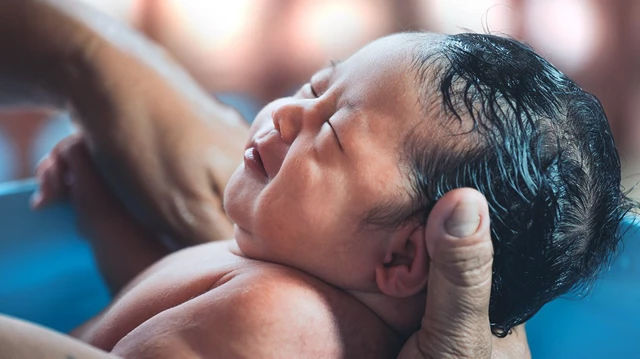 Baby in hands water birth