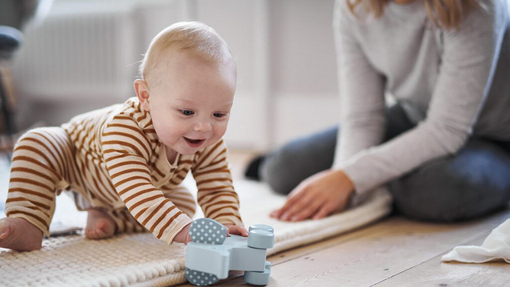 Baby Playing With Wooden Elephant