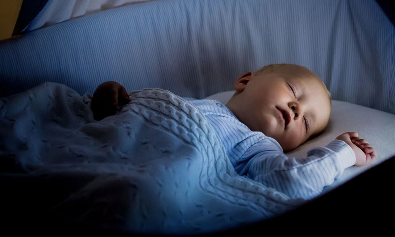 Baby sleeping in cot