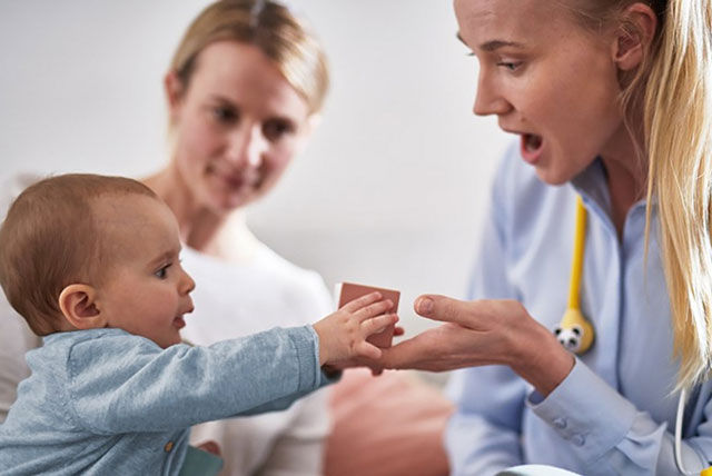 baby with mum and nurse