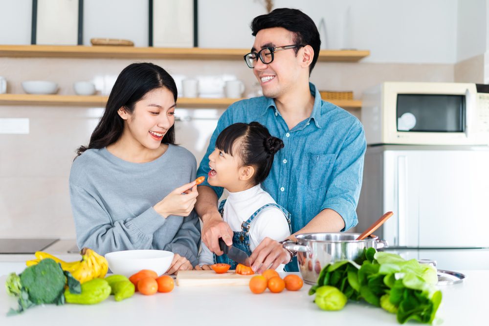 babyWithMomAndDadEatinCarrots.jpg