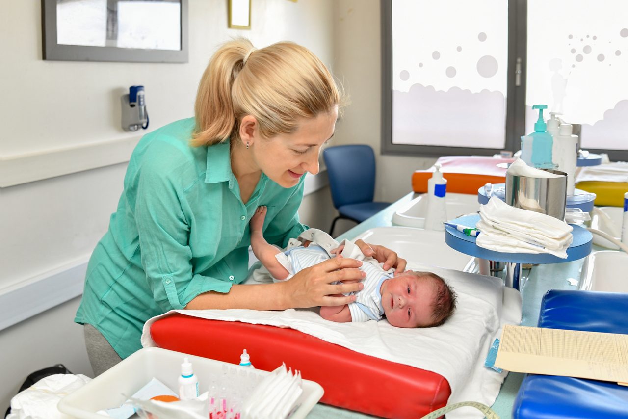 Mother cares for her newborn baby in the maternity hospital. First bath. getty images 1135857009