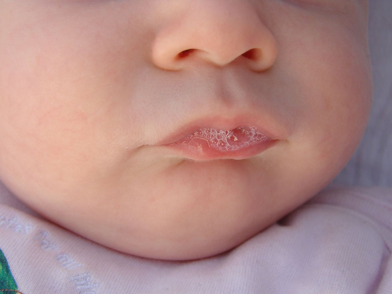 3 month old baby in the bubble production. In the bubbles reflects the grandma and the photographer.