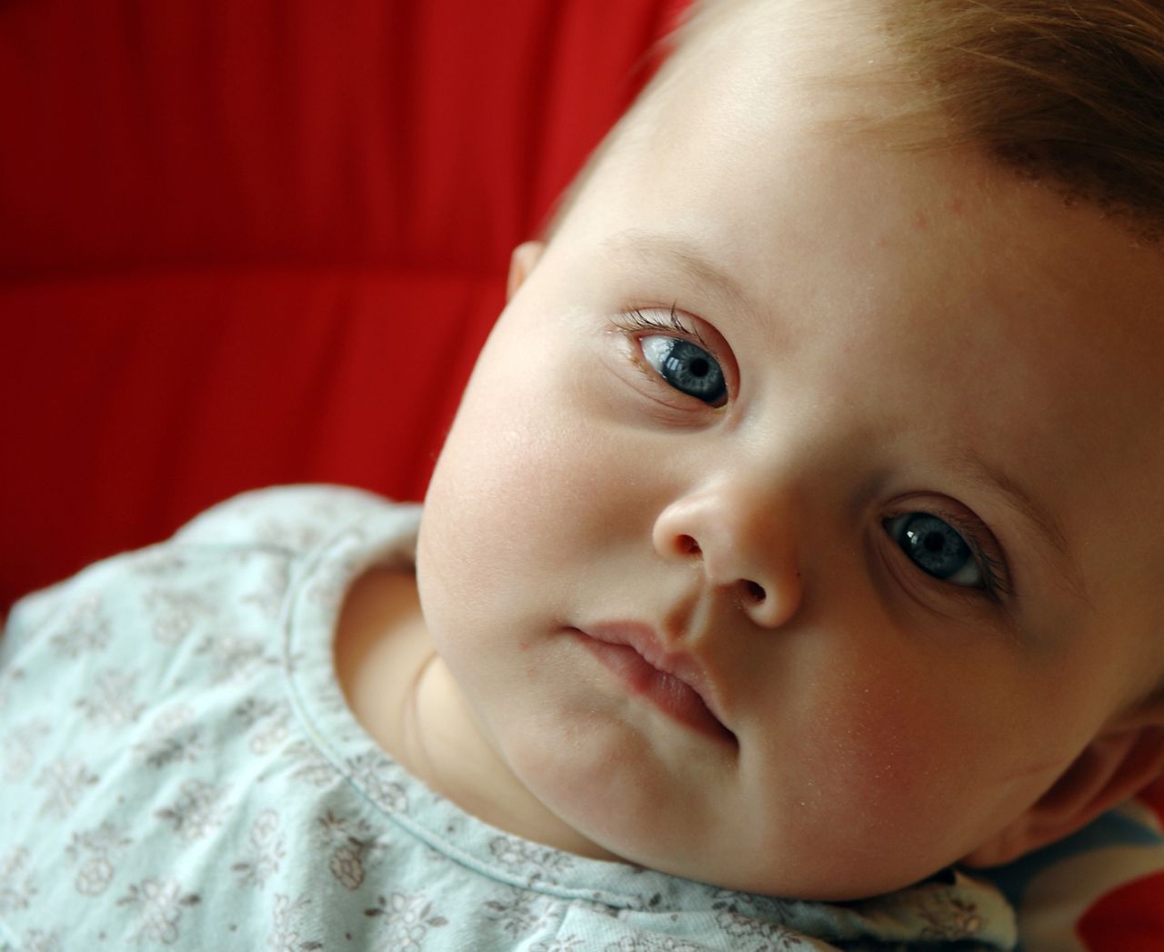 Close up of baby's face looking tired.