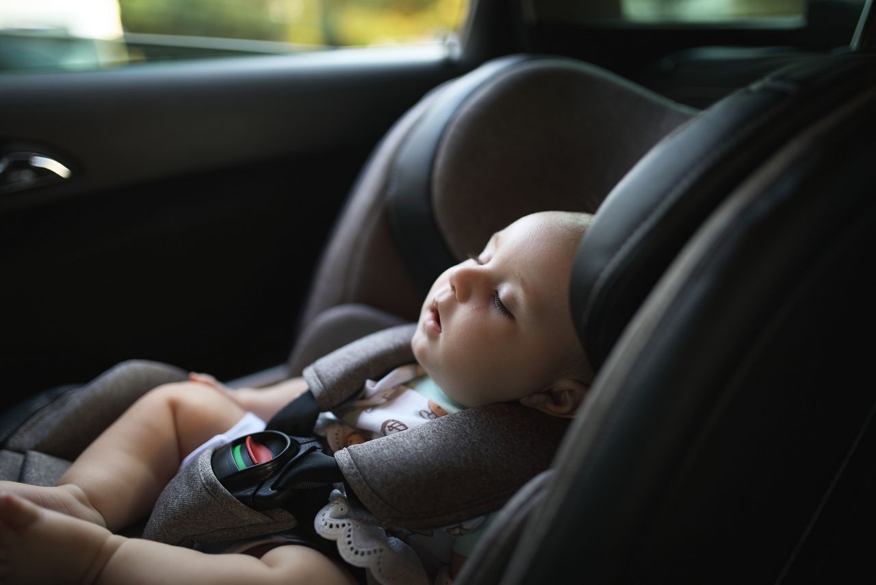 Baby sleeping in car safety seat while