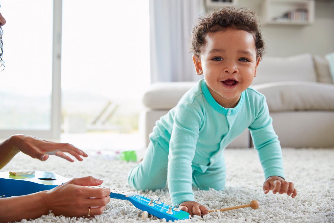 Mixed race mum and toddler son playing at home, close up