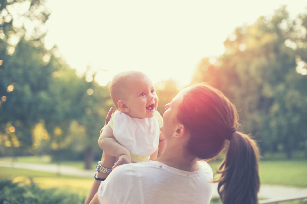 mother with baby playing in the park