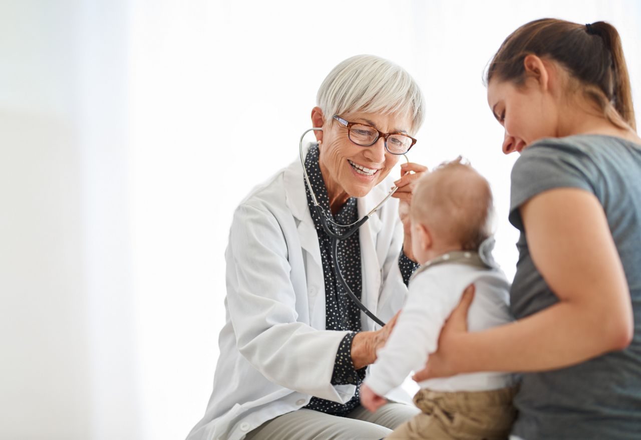 Shot of a young mother taking her baby daughter for a checkup at the doctorâ  s office