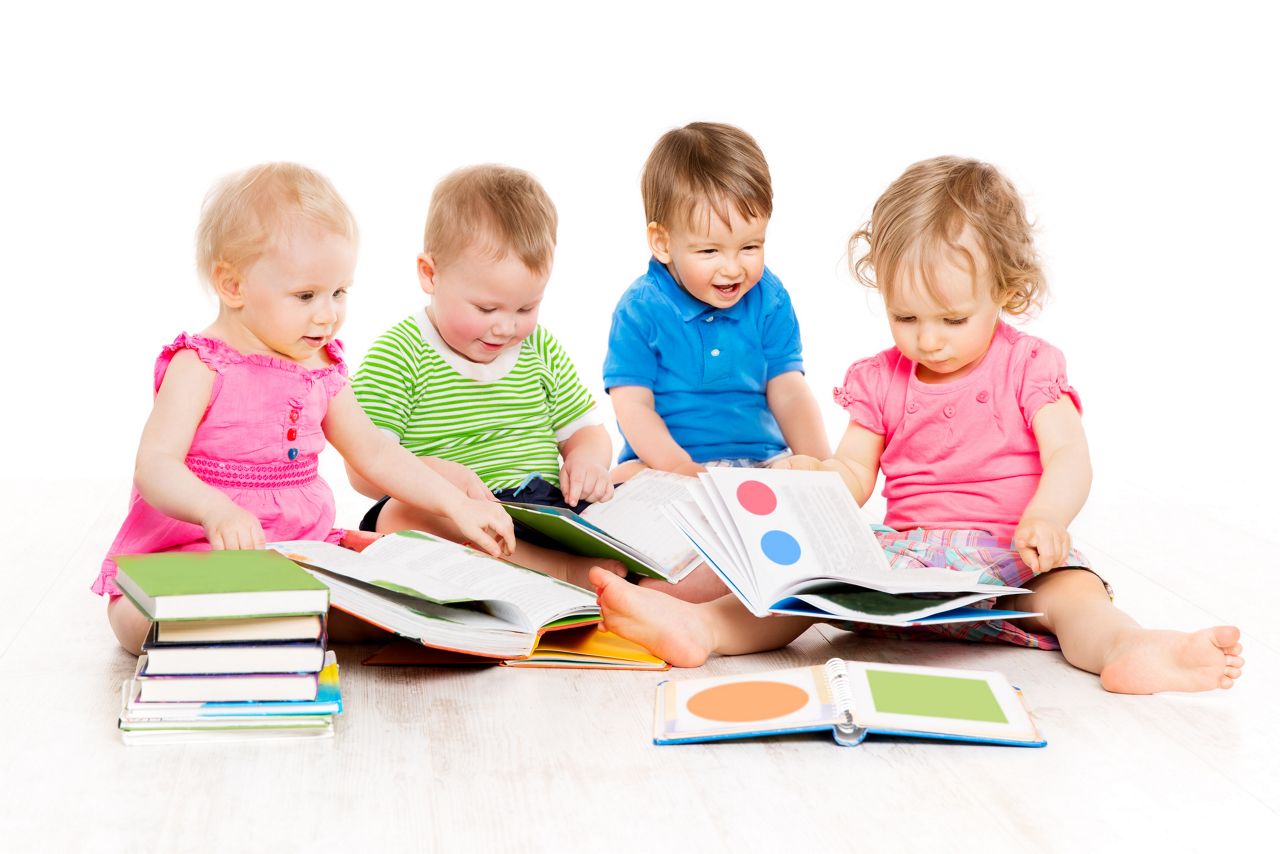 Children Reading Books, Babies Early Education, Group of Kids one year old, Boys and Girls Isolated over White Background