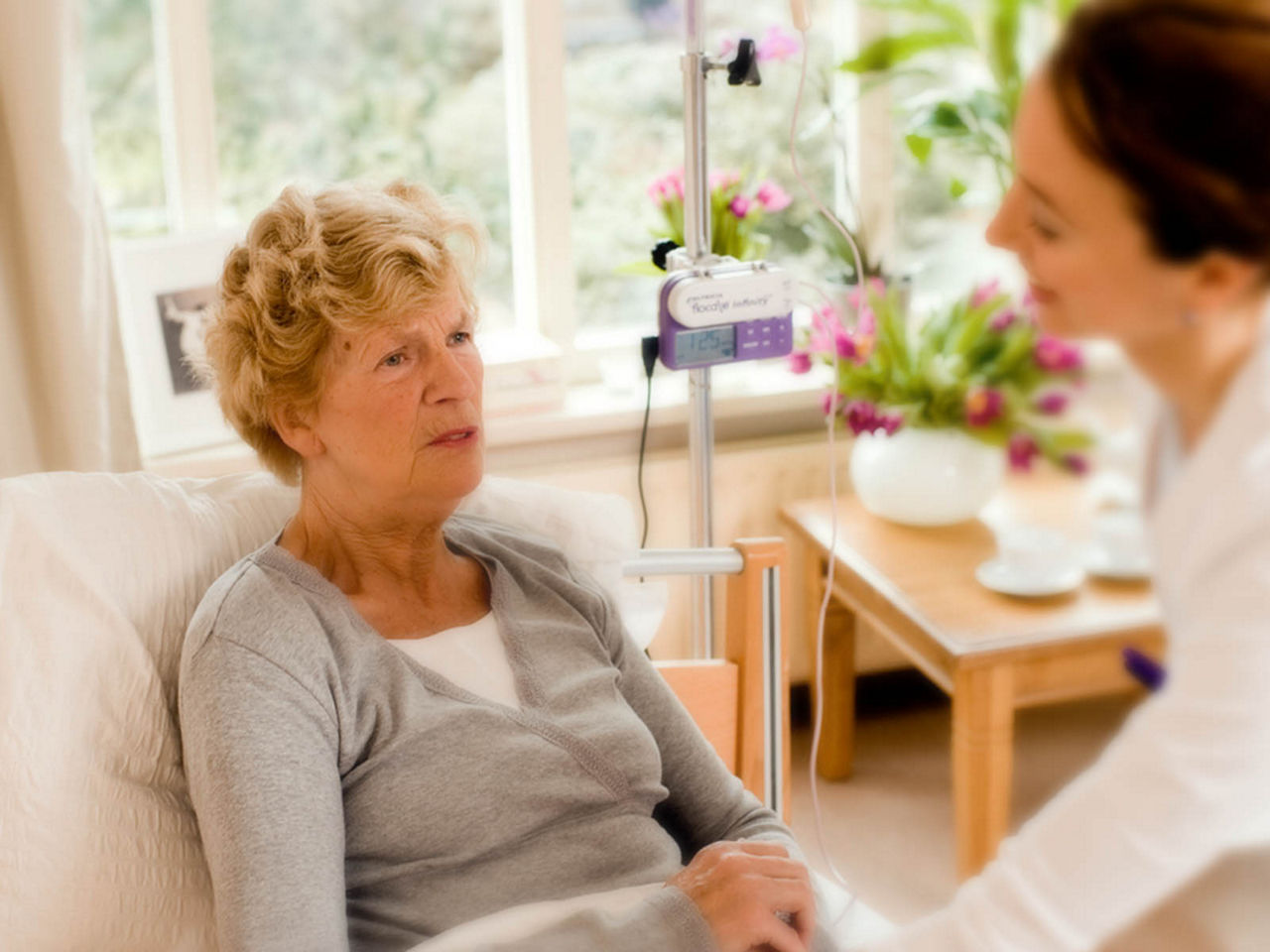 Close up of a nurse holding patient's hand